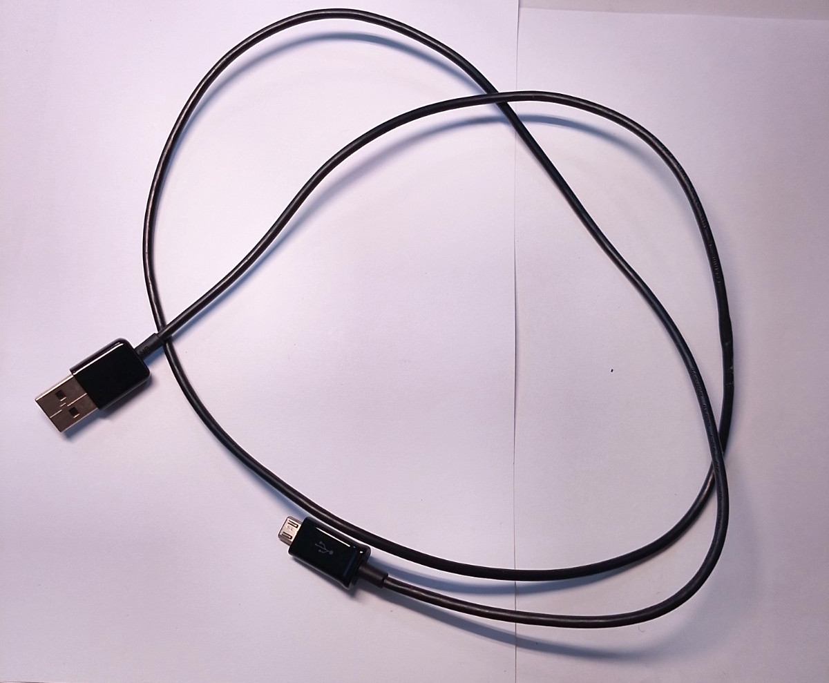 Spare untested cord lot and headphone lot with black bag