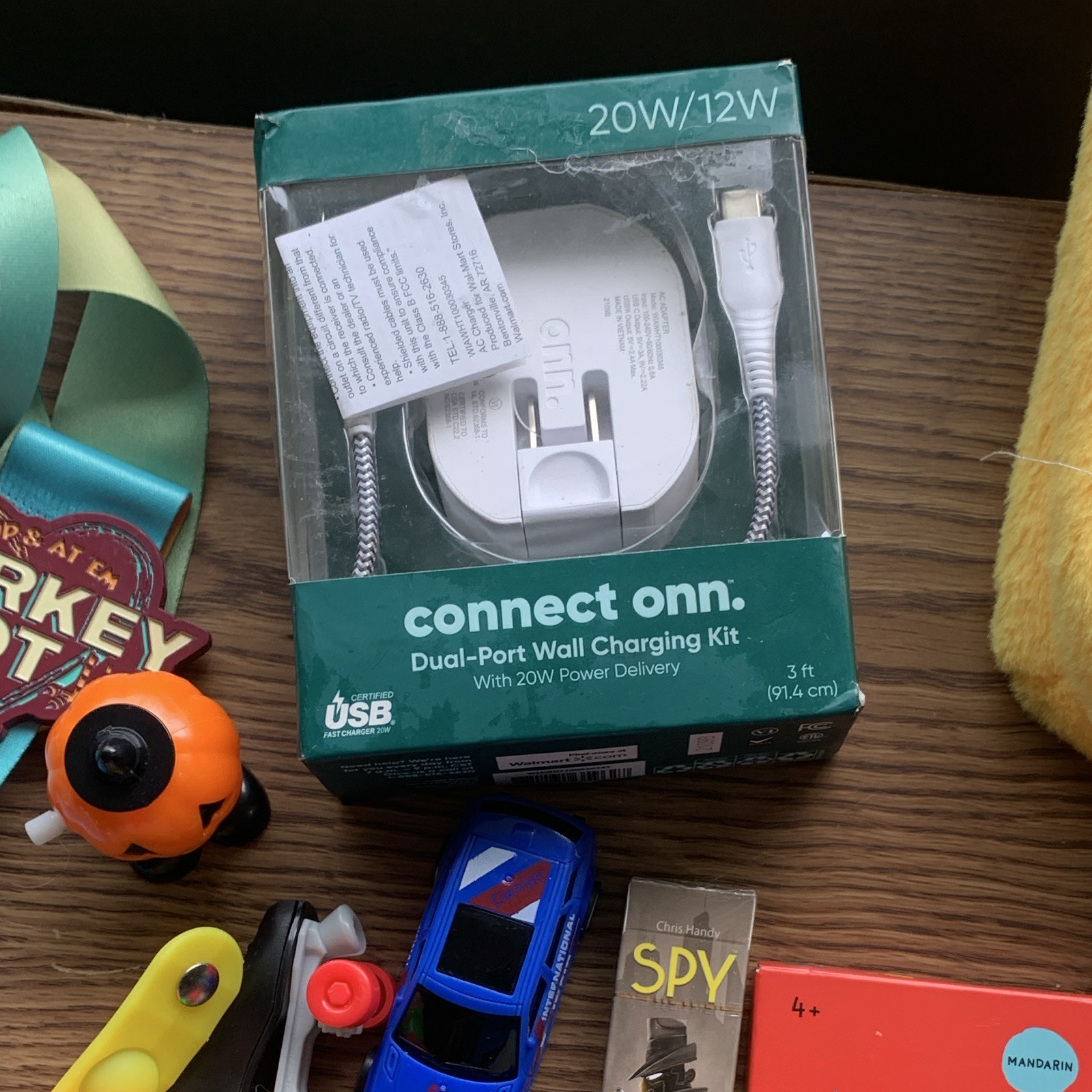 miscellaneous items including USB Wall Charger, card games, planner, yo yo, toys