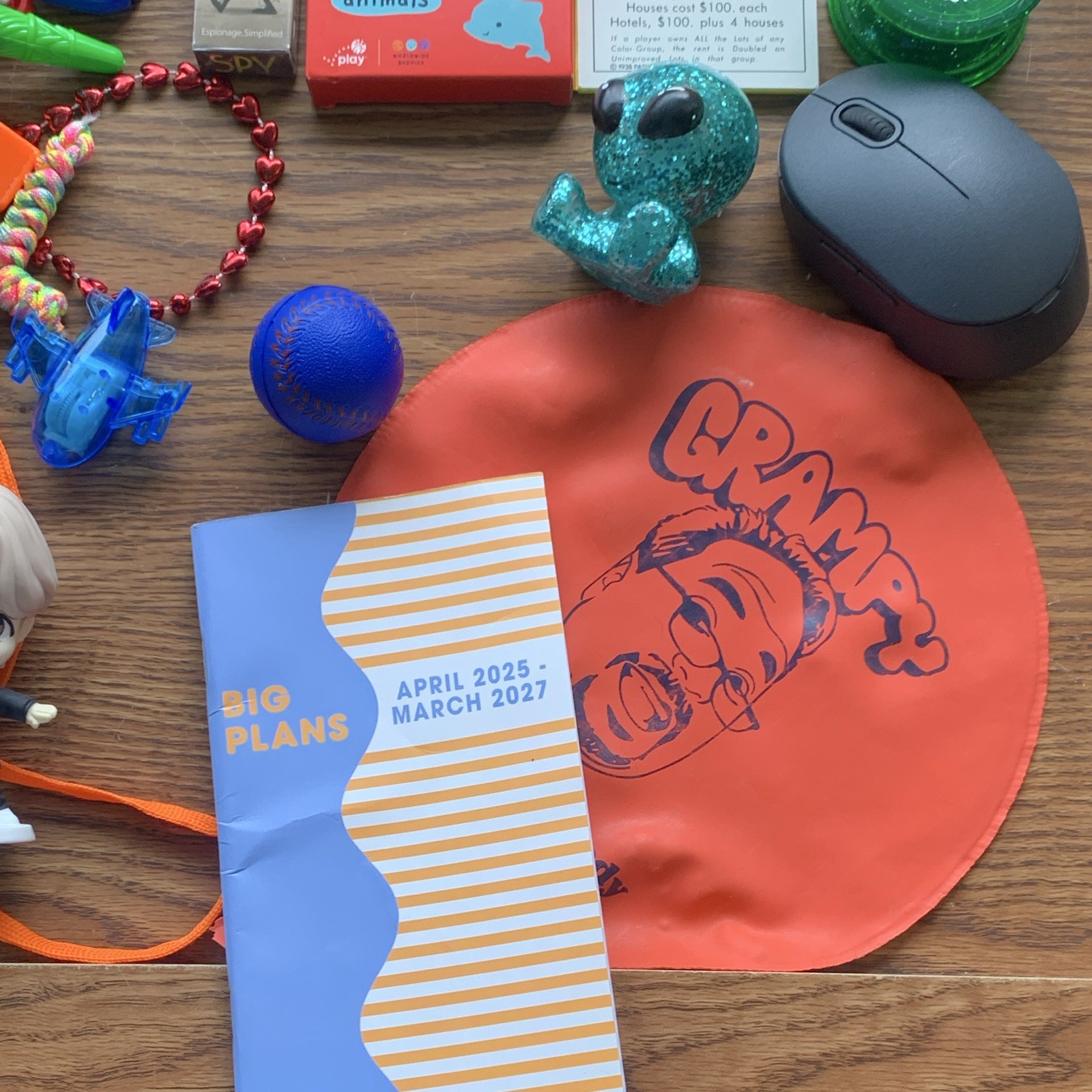 miscellaneous items including USB Wall Charger, card games, planner, yo yo, toys