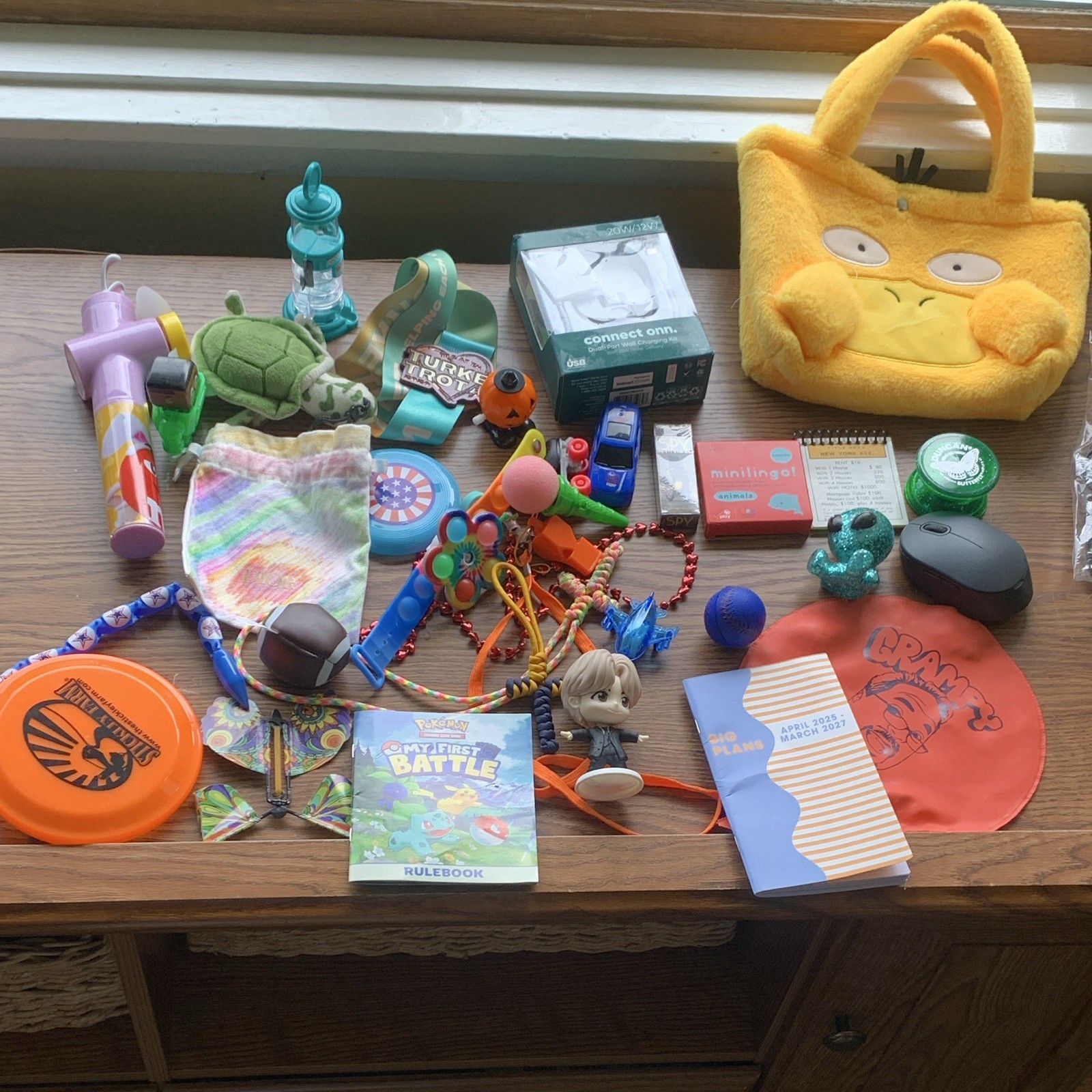 miscellaneous items including USB Wall Charger, card games, planner, yo yo, toys