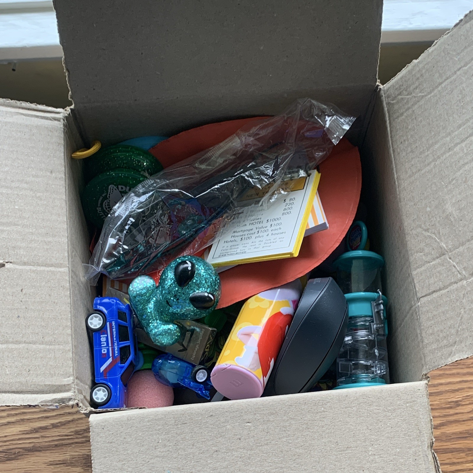 miscellaneous items including USB Wall Charger, card games, planner, yo yo, toys