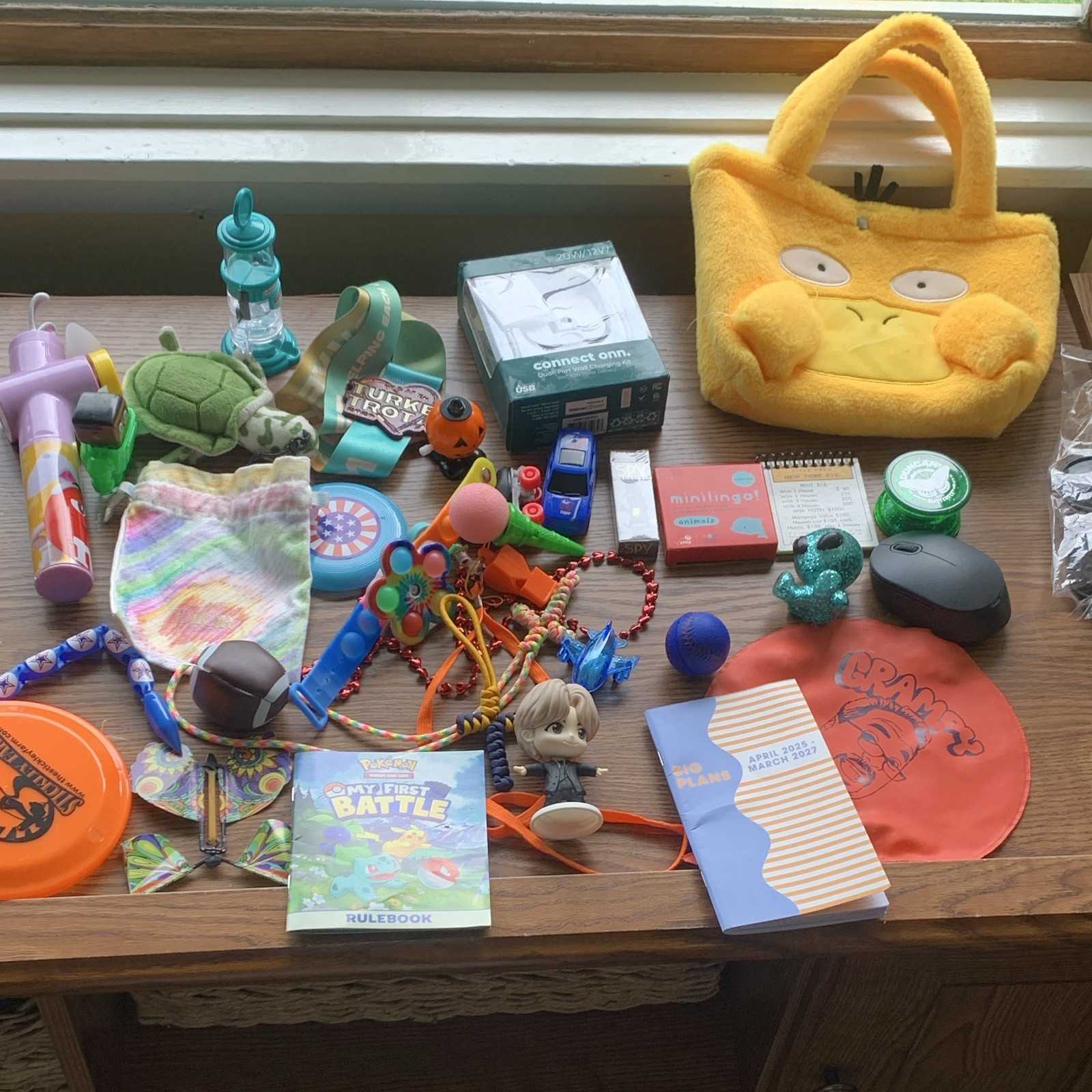 miscellaneous items including USB Wall Charger, card games, planner, yo yo, toys