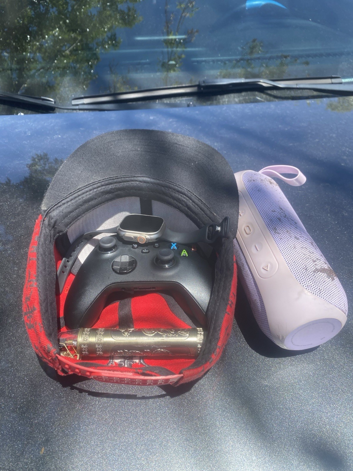 Apple Watch And Wireless Xbox Controller And Small Clipper And A Pink Bluetooth