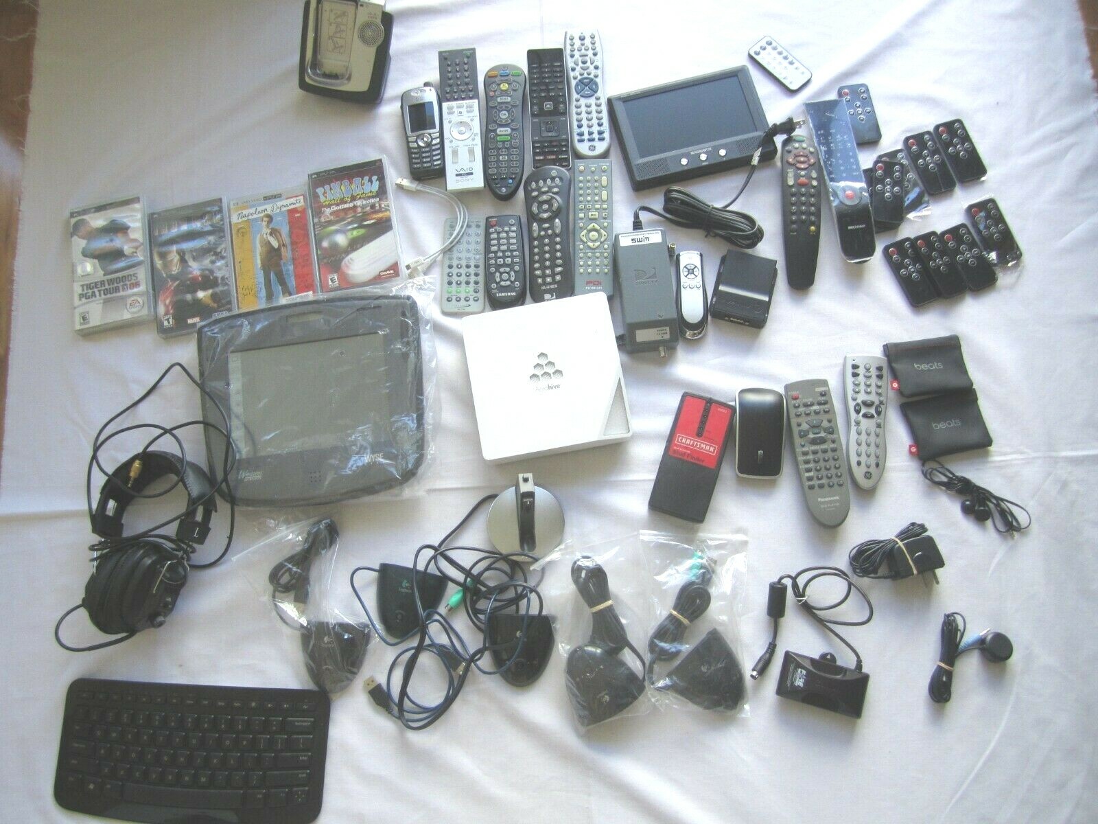 Mixed Lot of Electronics, remotes, Logitech receivers, PSP Games and more.. H